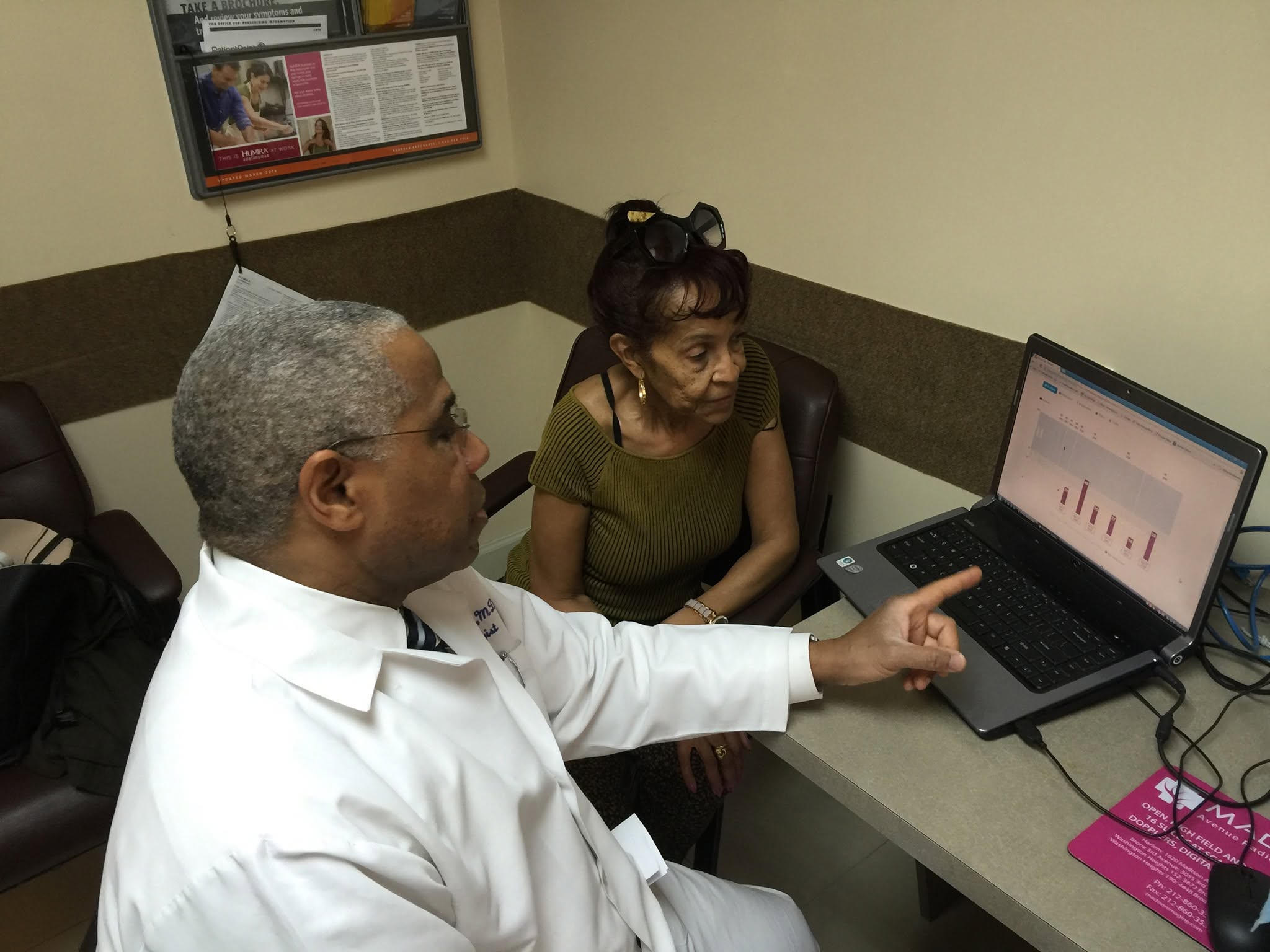 Rheumatology provider discussing care options with a patient during a consultation.